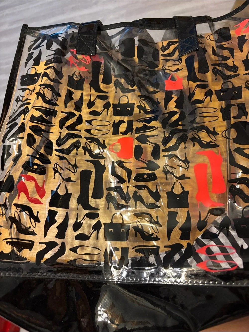 DSW Clear Pouch with Black Shoe Silhouettes and Red Accents with beach towel